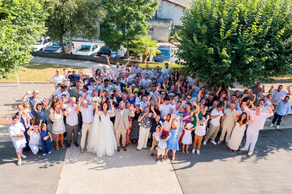 Photo de groupe avec les mariés devant la mairie de Villeneuve de Rivière (31) - Mariage de Sophie et Alain - 2025 - Photographe à Saint-Gaudens (31) Marc Villard / VILMAGE
